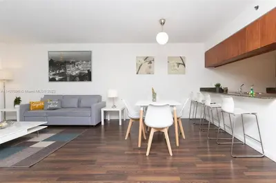 a living room with a couch and a table and chairs at Entire Condo in Brickell steps from Brickell City Centre in Miami