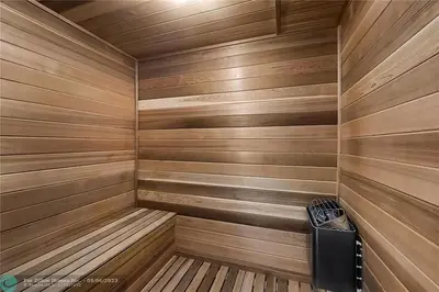 a small wooden sauna with a trash can in it at The Glamour of Upscale Downtown Ft. Lauderdale in Fort Lauderdale
