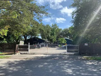 a fence in front of a park with a playground at 2 Bedroom Boutique Gem 10 min to the beach Washer Dryer Gated Parking Bliss 2 in Hollywood