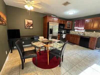 a kitchen with a table and chairs in a kitchen at 2 Bedroom Boutique Gem 10 min to the beach Washer Dryer Gated Parking Bliss 2 in Hollywood