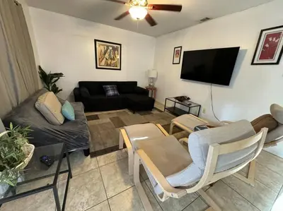 a living room with a couch and a flat screen tv at 2 Bedroom Boutique Gem 10 min to the beach Washer Dryer Gated Parking Bliss 2 in Hollywood