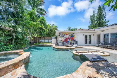 a swimming pool in the backyard of a house at Modern Tropical Pool House North Miami Hot Tub in Miami