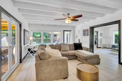 a living room with a couch and a ceiling fan at Modern Tropical Pool House North Miami Hot Tub in Miami