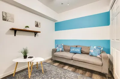 a living room with a couch and a table at Near Haulover Park Hollywood Cottage with Yard! in Hollywood