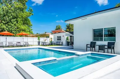 a swimming pool in the backyard of a house at Stylish 4 Bedroom Home with Pool, 12 Minutes to the beach in Miami
