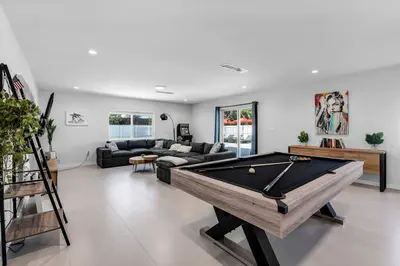 a living room with a pool table in it at Stylish 4 Bedroom Home with Pool, 12 Minutes to the beach in Miami