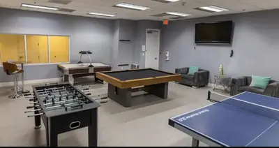 a room with a ping pong table and a tv at Sublime 1 BED 1 BTH • Brickell BAY & CITY VIEW in Miami