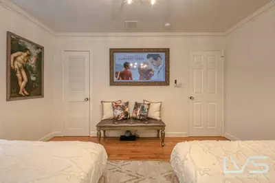 a bedroom with two beds and a bench with a picture on the wall at Floridita 5Bed 4Bath FTL Paradise with Tiki Hut Heated Pool in Fort Lauderdale