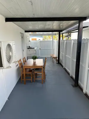 a patio with a table and chairs on a balcony at Adrien Guest Studio in Miami Gardens