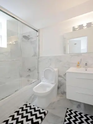 a bathroom with a toilet and a shower and a sink at Art Deco Washingthon Apartment in Miami Beach