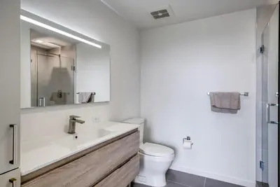 a white bathroom with a sink and a toilet at Blueground Wynwood gym roof pool nr Midtown MIA-101 in Miami