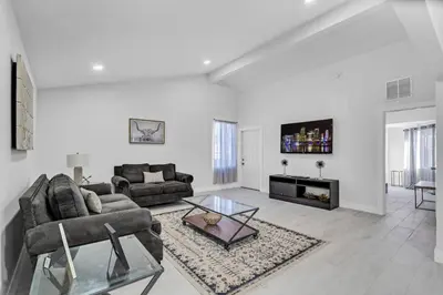 a living room with a couch and a table at Chic Miami Private Pool Home in Cutler Ridge