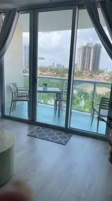 a room with a balcony with a table and chairs at Cozy newly furnished apartment , on the 6th floor. in Sunny Isles Beach