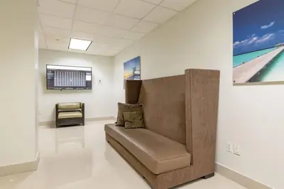 a couch in a room with a painting on the wall at Cozy newly furnished apartment , on the 6th floor. in Sunny Isles Beach