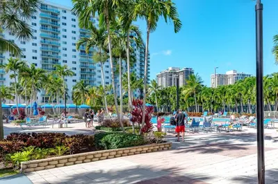a resort with palm trees and a pool at Cozy newly furnished apartment , on the 6th floor. in Sunny Isles Beach