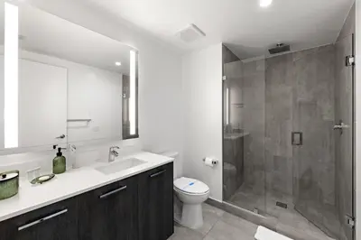 a bathroom with a shower and a toilet and a sink at Breezy Stays Luxury Residences - near Kaseya Center in Miami
