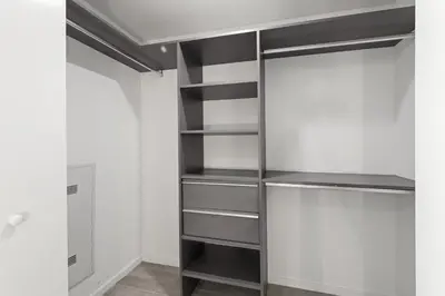 a walk in closet with black shelves at Breezy Stays Luxury Residences - near Kaseya Center in Miami