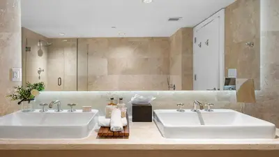 a bathroom with two sinks and a large mirror at Luxurious Private Condo at 1 Hotel & Homes - 1545 in Miami Beach