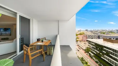 a balcony with a table and chairs on a building at Luxurious Private Condo at 1 Hotel & Homes - 1545 in Miami Beach