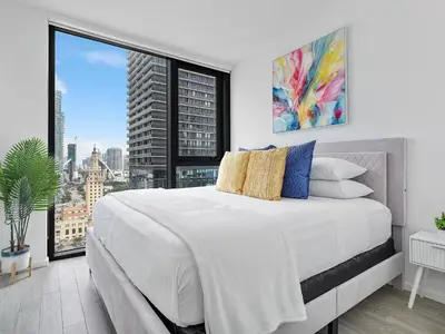 a bedroom with a large bed and a large window at X Lounge IV-Skyline Corner Residence in Miami