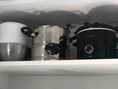 a shelf with two pots and a coffee maker at Cozy Studio Apartment in Miami