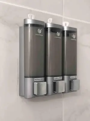 a group of three microwaves hanging on a wall at Cozy Studio Apartment in Miami