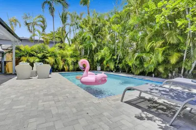 a pink flamingo float in a swimming pool at Casa Coral with Pool Charcoal BBQ area in Miami