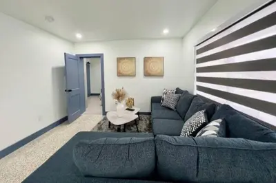 a living room with a blue couch and a table at Renovated Grand Villa Paradise Amazing pool, BBQ & Ping Pong in Tamiami