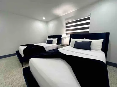 a bedroom with two beds and a chair at Sunny Resort Oasis with Heated Pool Ping Pong in Tamiami