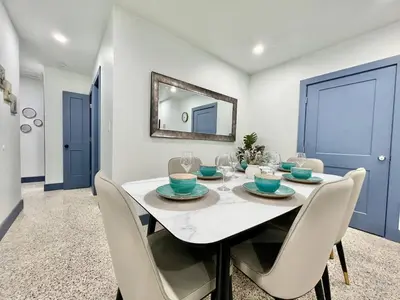 a dining room with a white table and chairs at Miami dream resort heated pool sleeps 8 in Tamiami