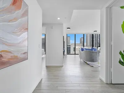a living room with a couch and a painting on the wall at X Lounge-Contemporary Corner Residence in Miami