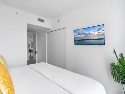 a white room with a bed and a picture on the wall at X Lounge-Contemporary Corner Residence in Miami