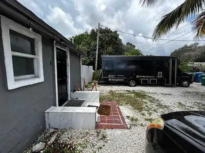 a ups truck parked next to a house at The Black Door miami in Miami