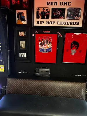 a wall with pictures and photos on a wall at The Black Door miami in Miami