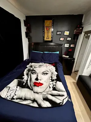 a bed with a picture of a woman with red lipstick at The Black Door miami in Miami