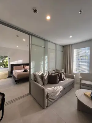 a bedroom with a couch and a bed in a room at Shaomi South Beach in Miami Beach