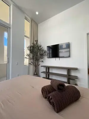 a brown towel sitting on a bed in a bedroom at Shaomi South Beach in Miami Beach