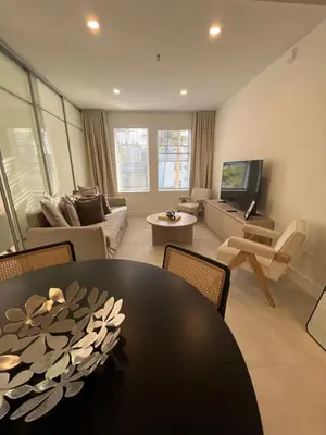 a living room with a table and a couch at Shaomi South Beach in Miami Beach