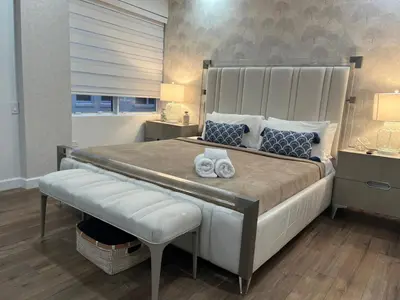 a bedroom with a large bed with towels on it at Shaomi South Beach in Miami Beach