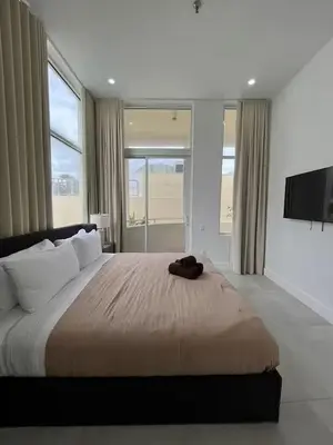 a bedroom with a large bed with a flat screen tv at Shaomi South Beach in Miami Beach
