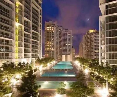 a large swimming pool in a city at night at Lovely 1BR W Icon Brickell-FREE SPA in Miami