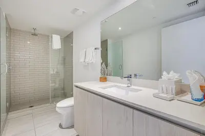 a bathroom with a sink and a toilet and a shower at Walk to Hollywood Beach Upscale 16th-Floor Condo in Hollywood