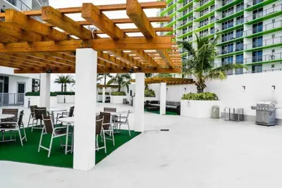 a patio with tables and chairs and a building at Beautiful apartment Miami, FL in Miami