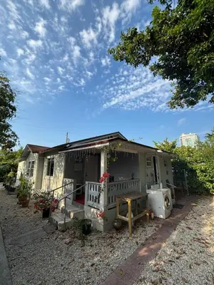 a small house with a porch on a gravel yard at Deluxe Room in best location Miami in a 2 Bedrooms Unit - Parking, Laundry and Luggage Storage in Miami