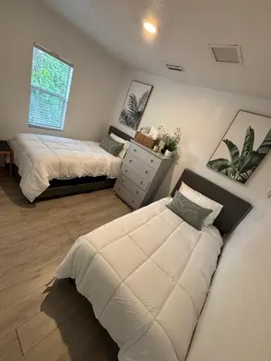 a bedroom with two beds and a window at House 2 Bedrooms plus CouchBed Best Location MIami Private Parking, Laundry, Storage for Luggage in Miami