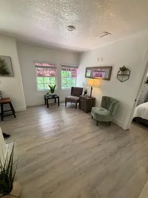 a living room with two chairs and a bed at House 2 Bedrooms plus CouchBed Best Location MIami Private Parking, Laundry, Storage for Luggage in Miami