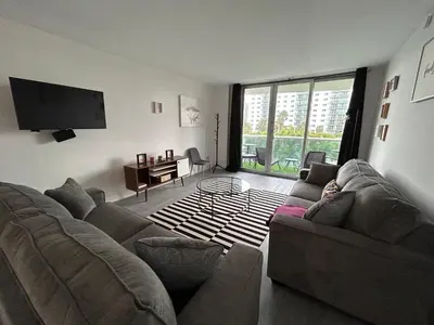 a living room with a couch and a flat screen tv at #310 Sunny Isles Ocean Reserve with FREE Parking include in Sunny Isles Beach