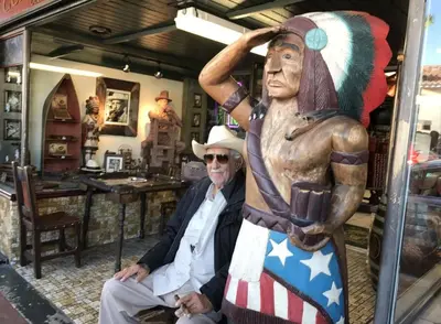 a man sitting next to a statue in a store at B3 Best Value on Private Bedroom with Private Bathroom in Little Havana, Miami in Miami