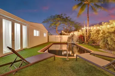a backyard with a swimming pool and a house at Modern home w heated pool canal views in Hollywood
