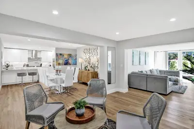 a living room with a couch and a table at Modern home w heated pool canal views in Hollywood